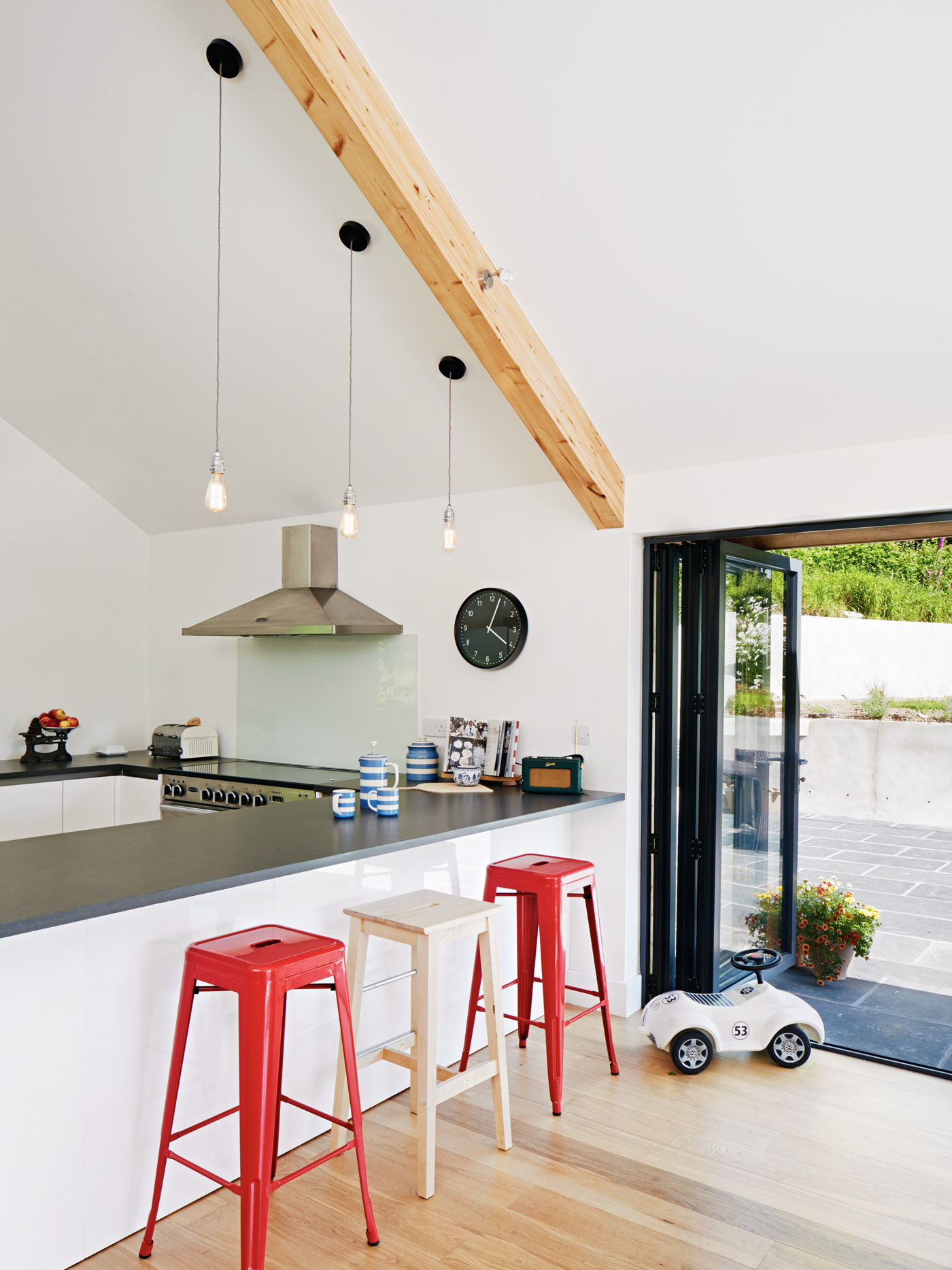 Modern kitchen with breakfast bar and bi-fold doors